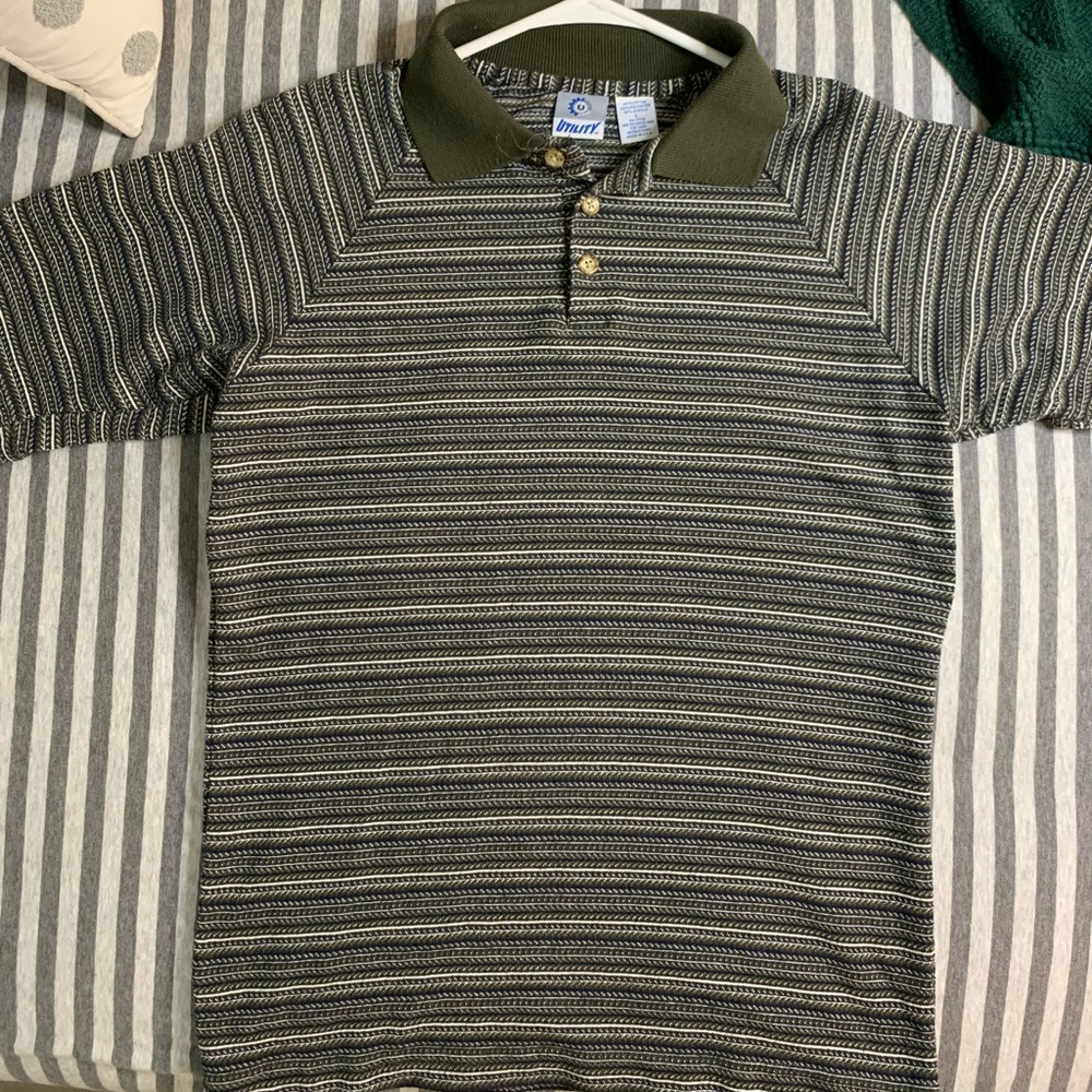 Polo with green designs. Size large but fits more like a medium.